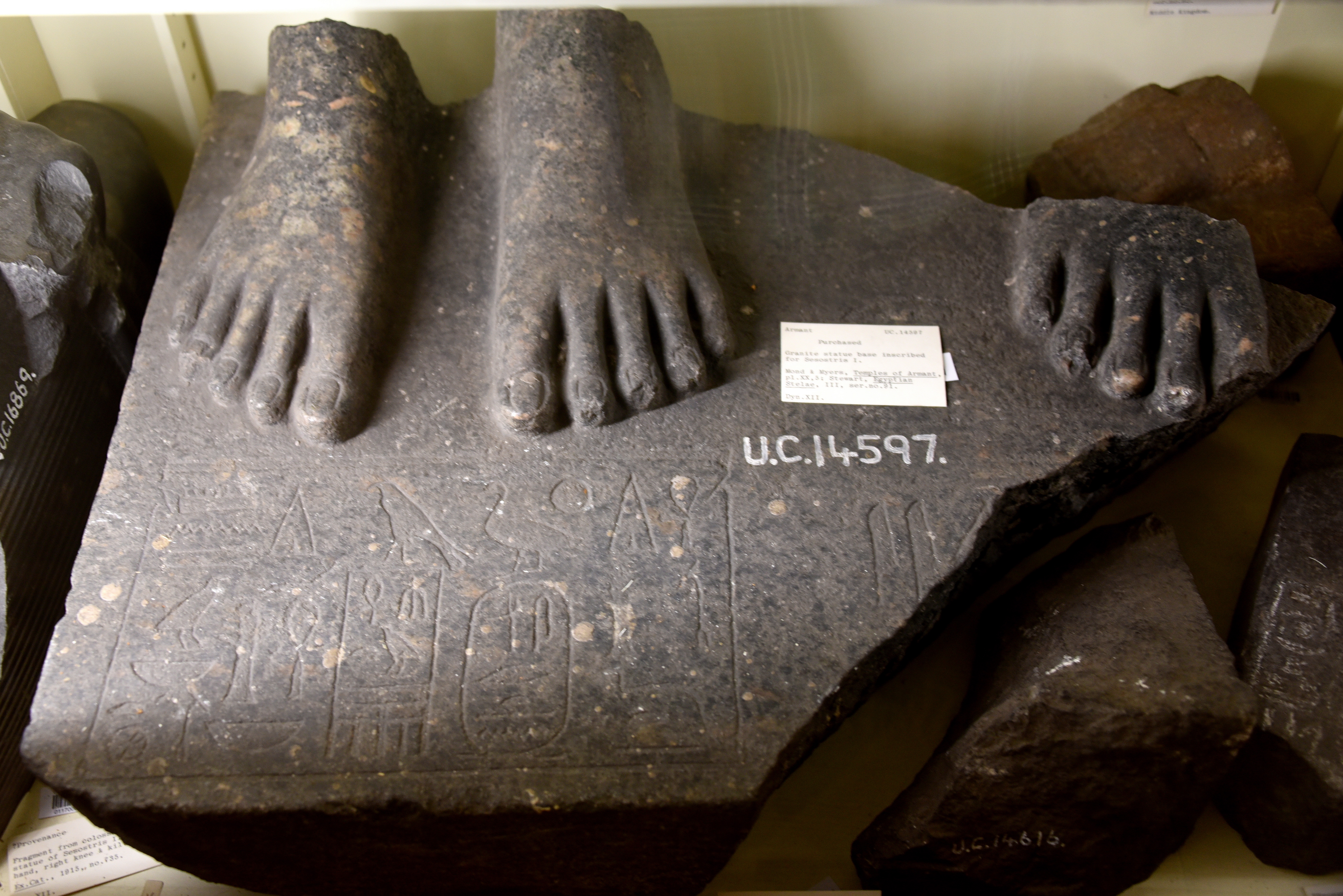 FileBase_of_a_granite_statue_inscribed_with_the_name_of_Senusret_Sesostris_I._Two_feet_of_a_female_figure_at_the_right_side_of_the_right_foot_of_the_king._From_Armant_Egypt.jpg