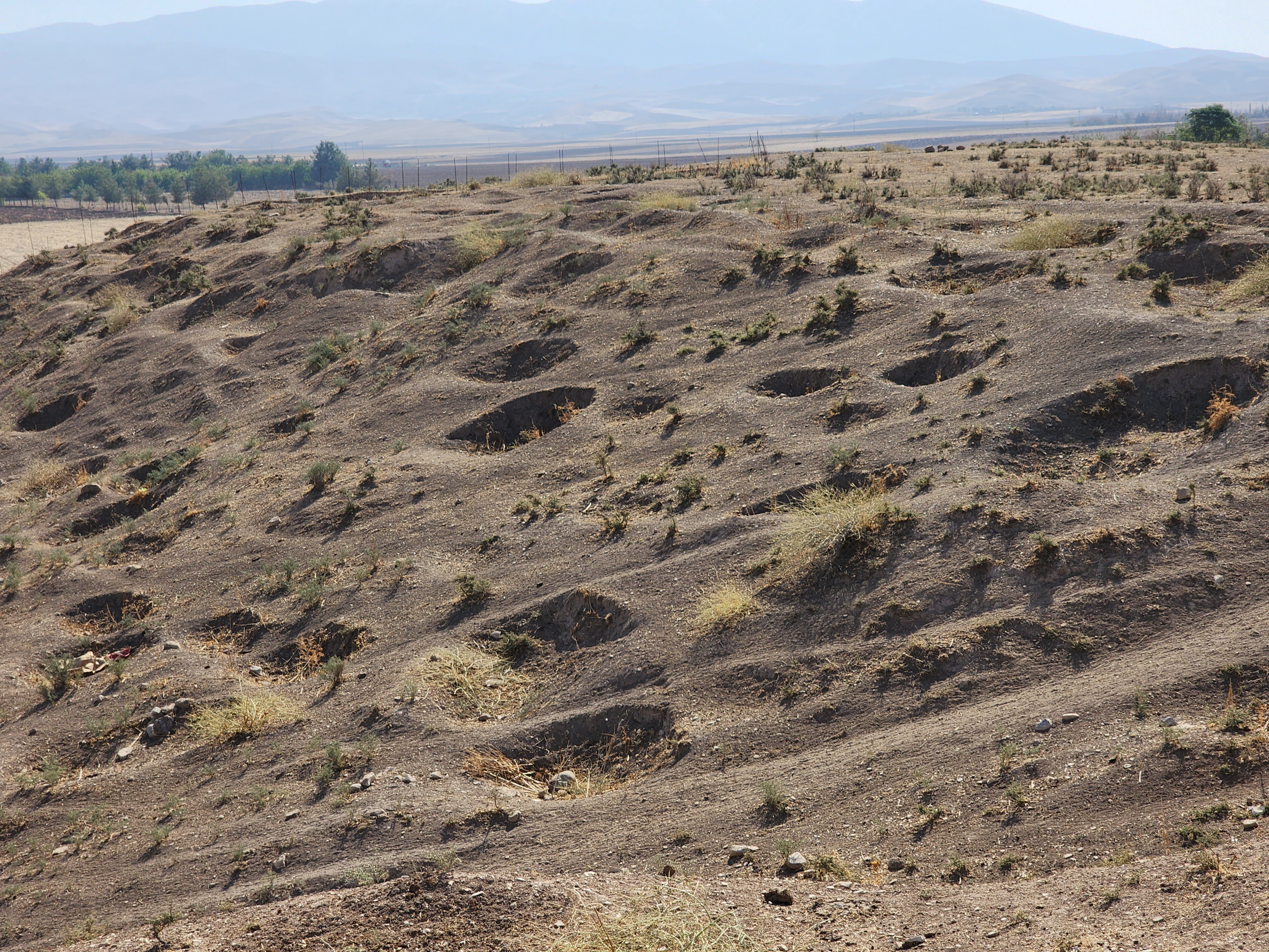 File106._The_archeological_site_of_Bakr_Awa_an_ancient_mound_near_Halabja_Shahrizor_Plain_Sulaymaniyah_Iraq._November_4_2022._The_tell_and_its_surrounding_area_were_lastly_excavated_in_2014._An_area_before_the_tell.jpg