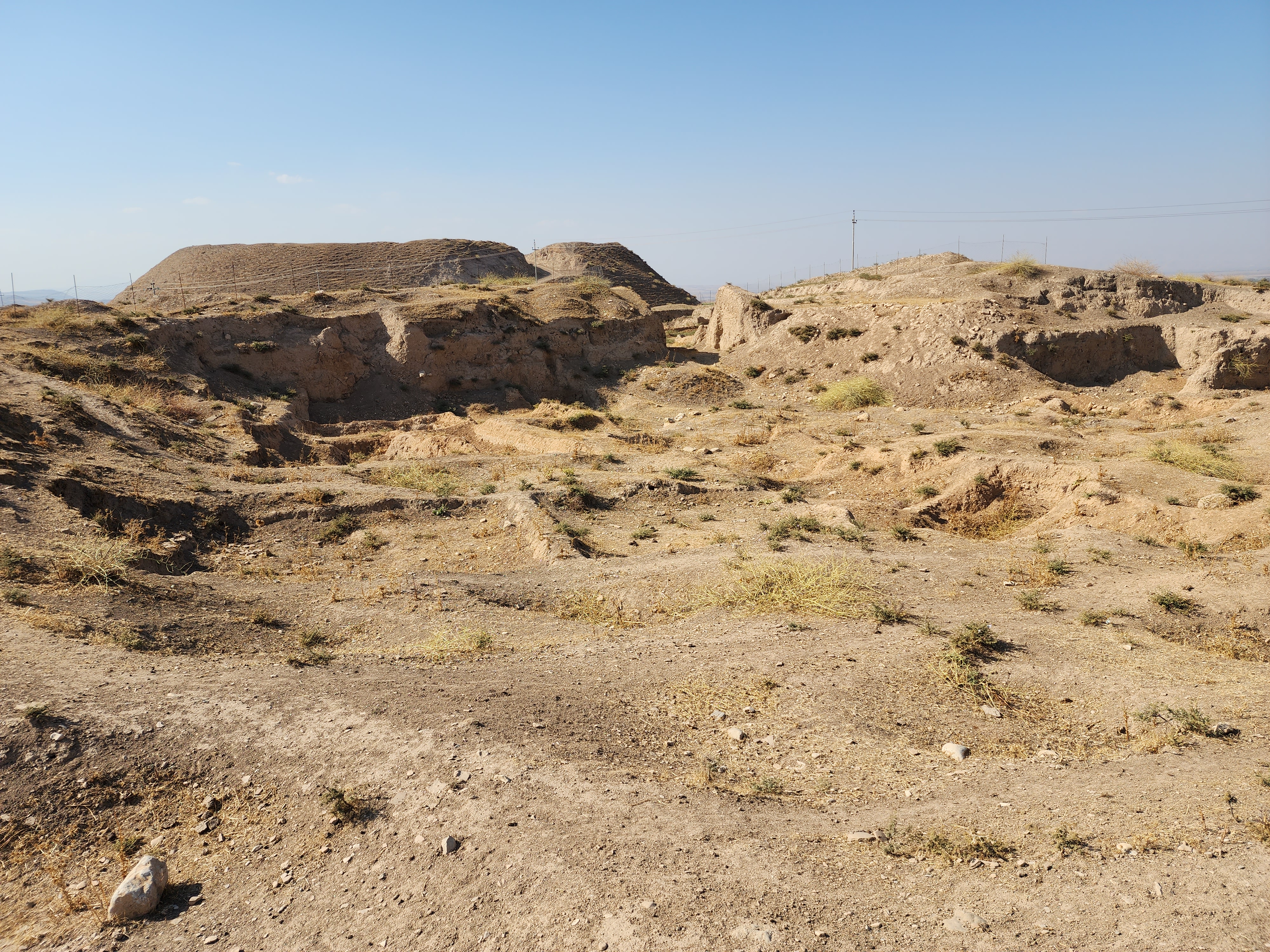 File110._The_archeological_site_of_Bakr_Awa_an_ancient_mound_near_Halabja_Shahrizor_Plain_Sulaymaniyah_Iraq._November_4_2022._The_tell_and_its_surrounding_area_were_lastly_excavated_in_2014._An_area_before_the_tell.jpg