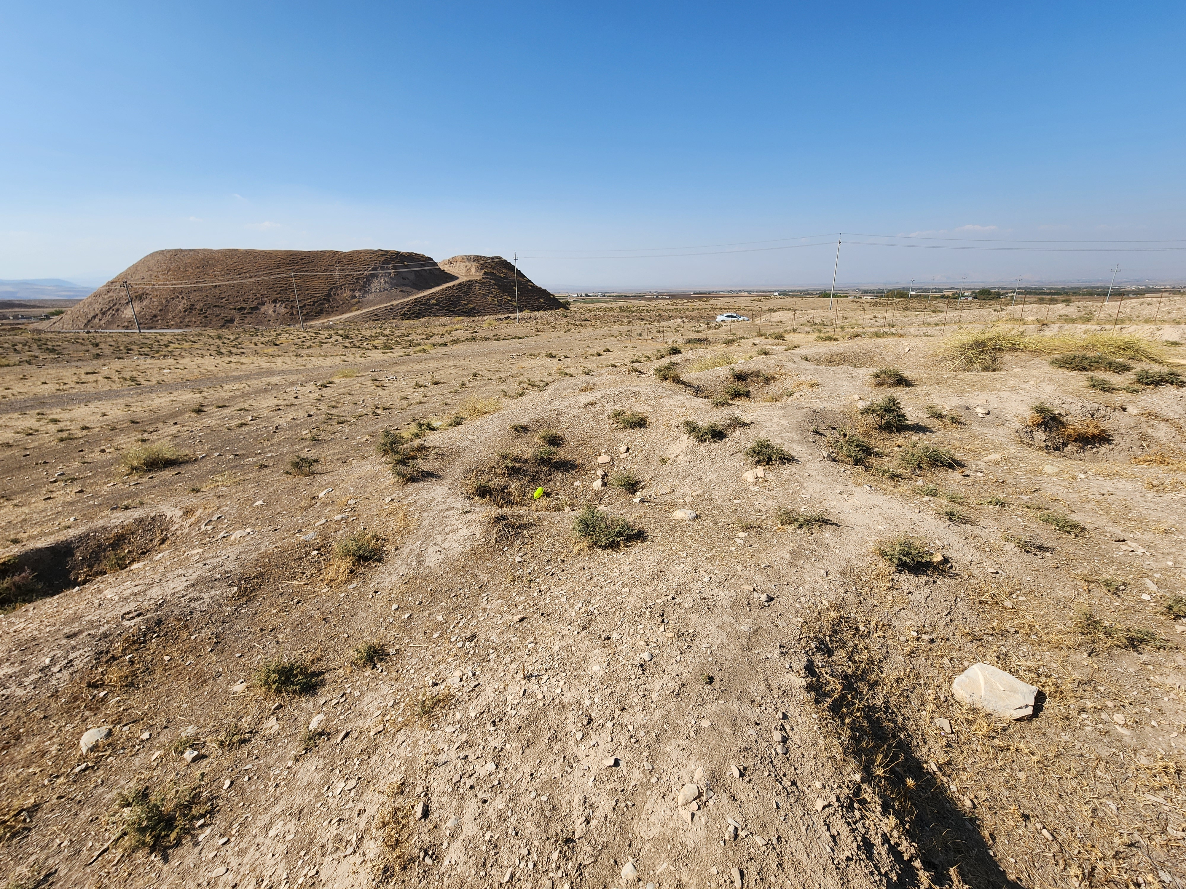 File154._The_archeological_site_of_Bakr_Awa_an_ancient_mound_near_Halabja_Shahrizor_Plain_Sulaymaniyah_Iraq._November_4_2022._The_tell_and_its_surrounding_area_were_lastly_excavated_in_2014._An_area_before_the_tell.jpg