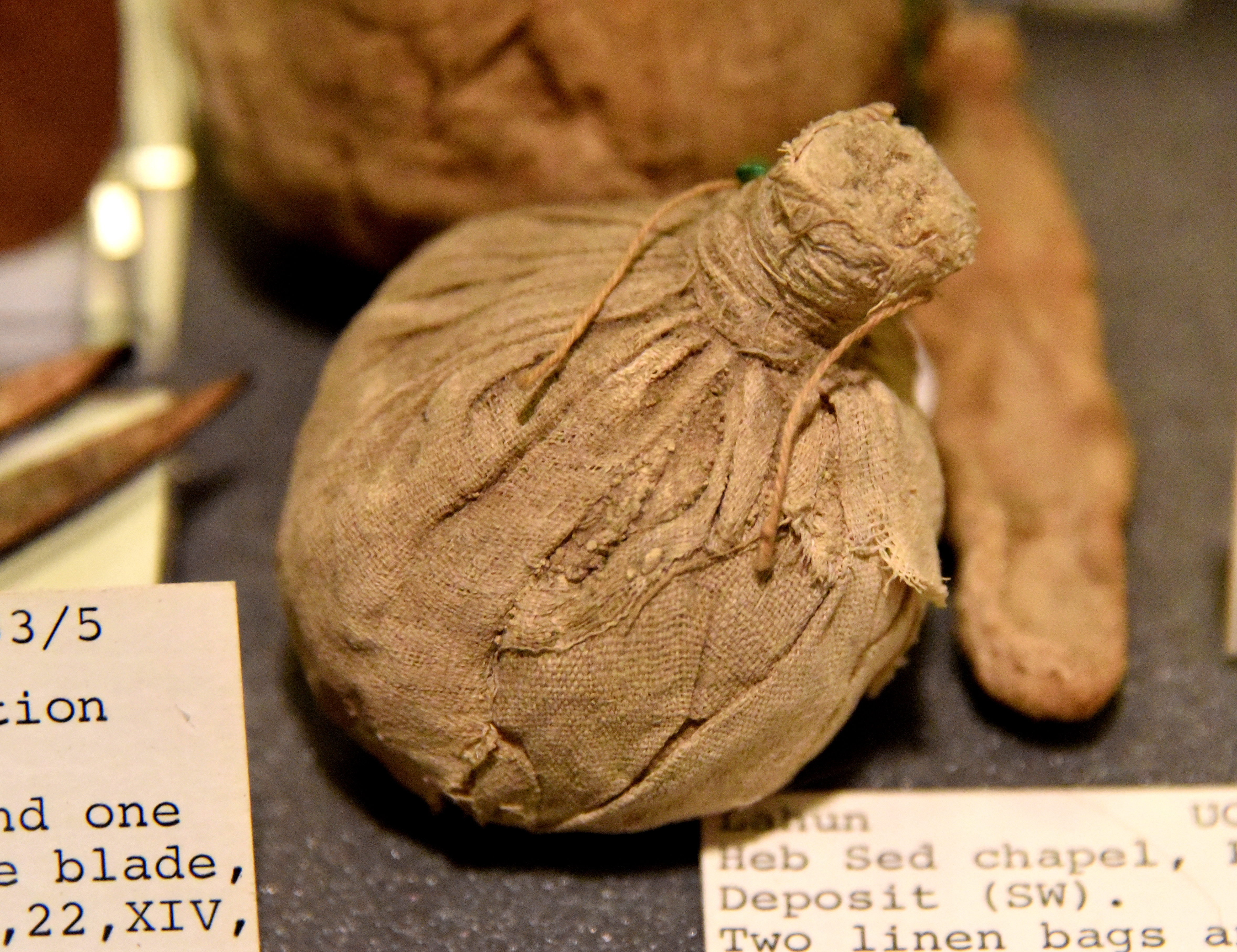 FileA_bag_of_white_linen_unopened._Contains_rolls_of_linen_only._Foundation_deposit_Heb_Sed_Chapel_at_Lahun_Fayum_Egypt._12th_Dynasty._The_Petrie_Museum_of_Egyptian_Archaeology_London.jpg