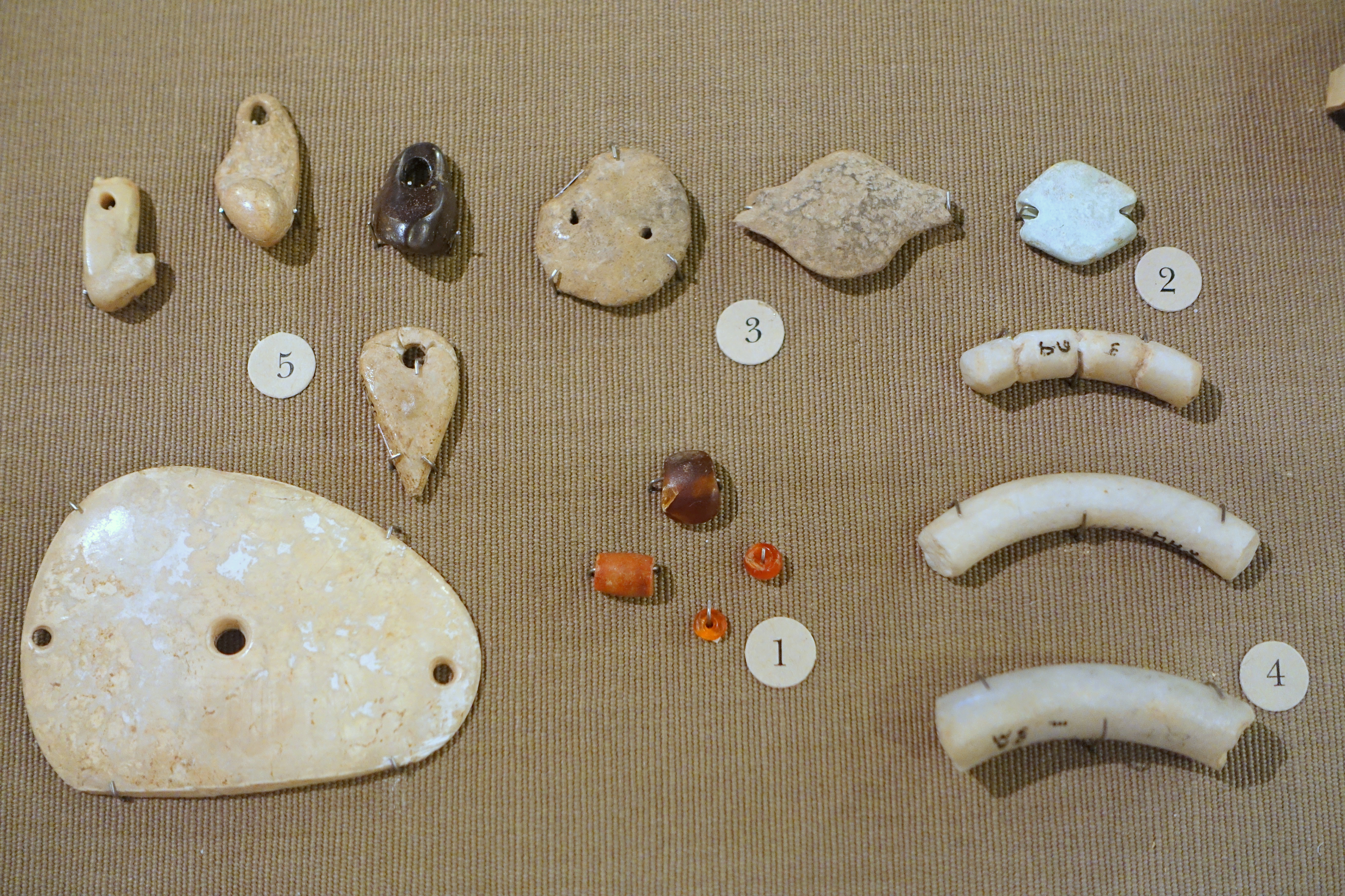 FileJarmo_personal_adornments_1_carnelian_beads_2_turquoise_bead_3_clay_beads_4_stone_bracelets_5_pendants_of_clay_stone_and_shell_-_Oriental_Institute_Museum_University_of_Chicago_-_DSC06938.JPG
