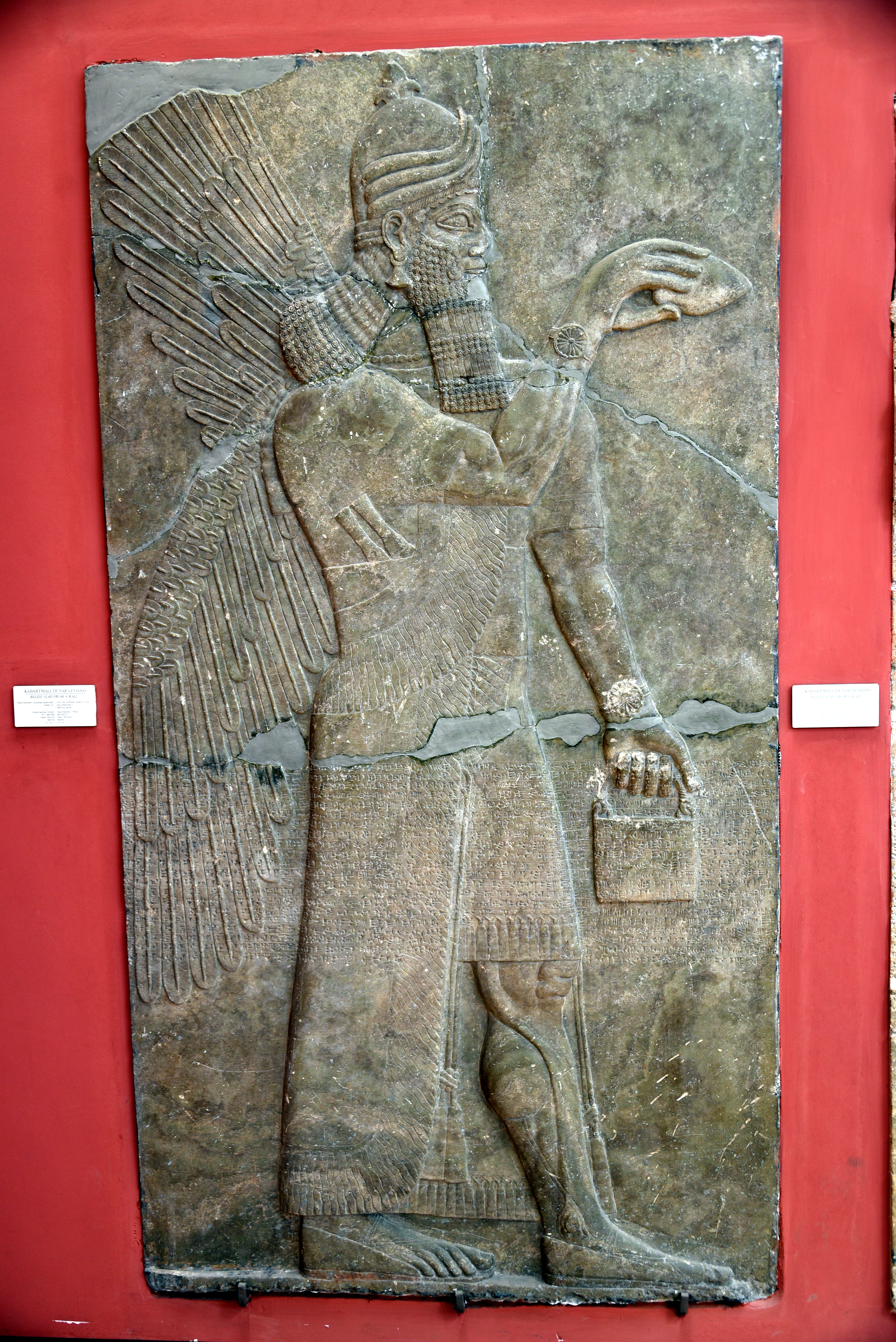 FileA_human-headed_and_winged_apkallu_holding_a_pine_cone_and_bucket_for_religious_rituals._From_the_North-West_of_Ashurnasipal_II_at_Nimrud_Iraq_883-859_BCE._Alabaster-bas_relief._Museum_of_the_Ancient_Orient_Istanbul_Turkey.jpg